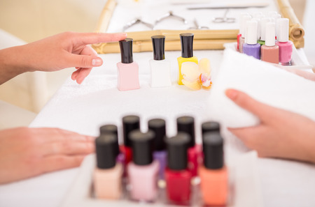 Manicurist working on her client's nails at beauty salon.の写真素材