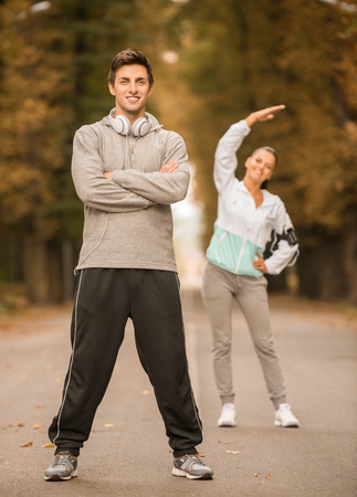 Young people in sports wear workout together in the park. Fitness, sport, friendship and lifestyle conceptの写真素材