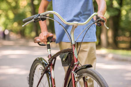 Picture of man with bicycle in the park, close-up.