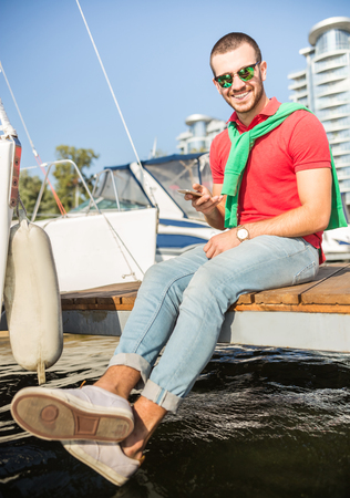 Young successful businessman sitting on the yacht.の写真素材