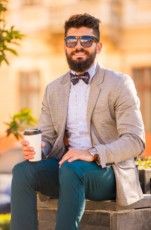 Stylish young man with a beard, a walk in the parkの写真素材