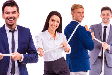 A group of young business people smiling on a white background. Studio shooting