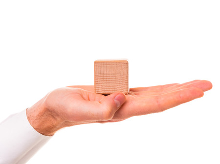 Creative idea. Young businessman presenting creative idea using wood cubes. Studio shooting isolated on white backgroundの写真素材