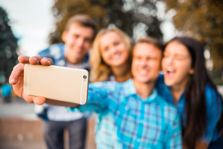 Funny young students, organized a fun time for a walk in the parkの写真素材