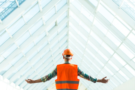 Portrait of a man construction builder in yellow helmet and vest the office centerの写真素材