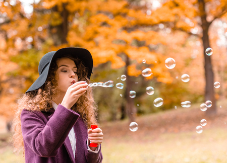 Autumn walk. Young beautiful girl on a walk in the parkの写真素材