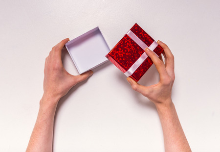 Hand holding box for a gift isolated on a white backgroundの写真素材