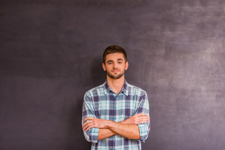 Portrait of a young guy, express their emotions on gray backgroundの写真素材