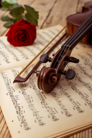 Violin and notes close up lying on the wood tableの写真素材