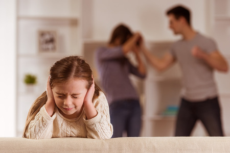 ?hild suffering from quarrels between parents in the family at homeの写真素材