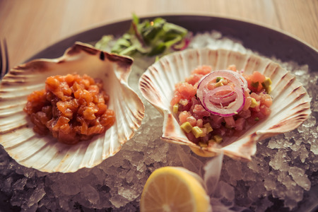 Top view of light seafood perfect for lunch served on shell and with ice, on the wooden tableの写真素材