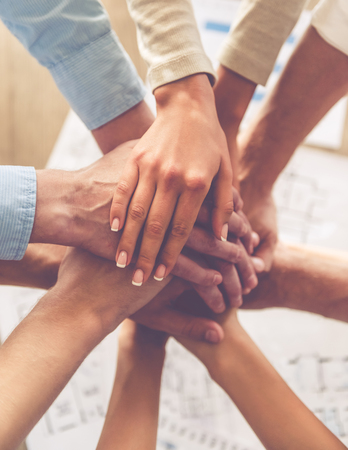 Top view of business people holding hands together, croppedの写真素材