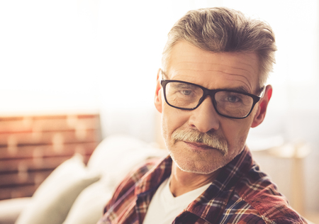 Portrait of handsome mature man in casual clothes and glassesの写真素材