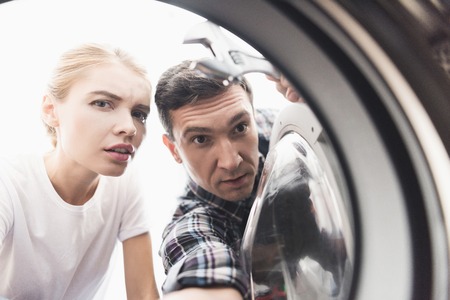 The woman called the repairman of washing machines. A photograph of the drum of a washing machine.の写真素材