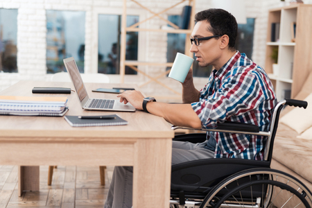 A young disabled man works at home.の写真素材