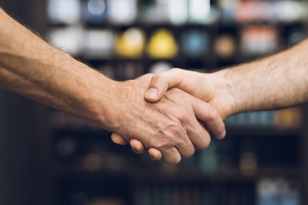 The men greet each other and shake hands.の写真素材