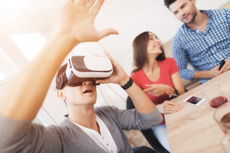 Young people have fun in the helmet of virtual reality.の写真素材