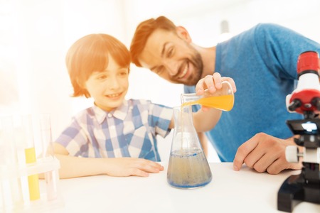 Father and son conduct chemical experiments at home.の写真素材
