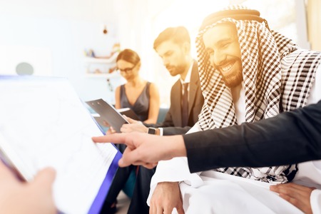 An arab businessman is discussing a business deal with his business partners.の写真素材
