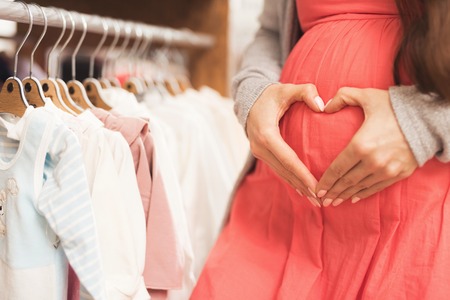 A pregnant woman chooses baby goods in the store.の写真素材