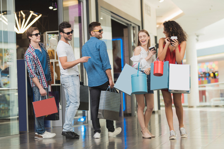 Sale in black Friday. The company of young people are engaged in shopping on a black Friday.の写真素材