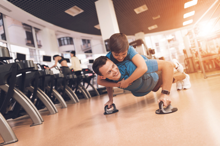 Dad and son in the same clothes in gym. Father and son lead a healthy lifestyle.の写真素材