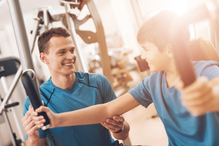 Dad and son in the same clothes in gym. Father and son lead a healthy lifestyle.の写真素材