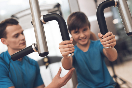 Dad and son in the same clothes in gym. Father and son lead a healthy lifestyle.