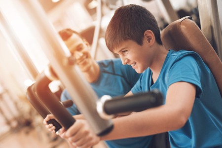 Dad and son in the same clothes in gym. Father and son lead a healthy lifestyle.の写真素材