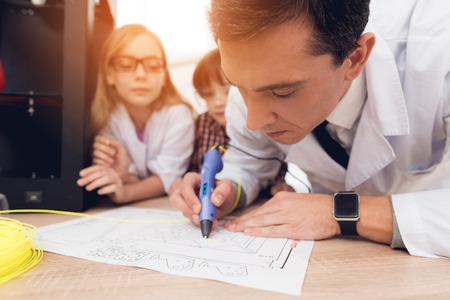 Man writes by 3d pen during a lesson in class.