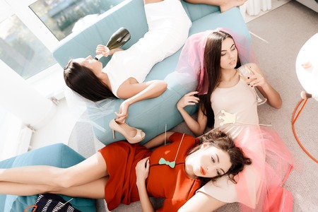 Girls have a great time at the hen-party. Bridesmaids and bride celebrating with champagne.の写真素材