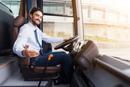 The driver of the tourist bus is smiling and looking at the camera.の写真素材