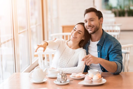 A guy and a girl are sitting together in a cafe.の写真素材