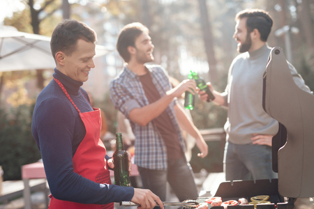 A man is cooking barbecue food.の写真素材