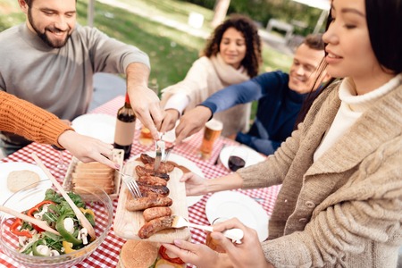 A company of young people came together for a barbecue.の写真素材