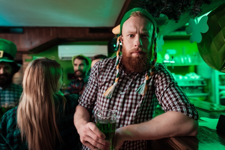A man in a funny hat celebrates St. Patricks Day.の写真素材