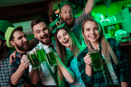 A company of young people is resting in a beer bar.の写真素材