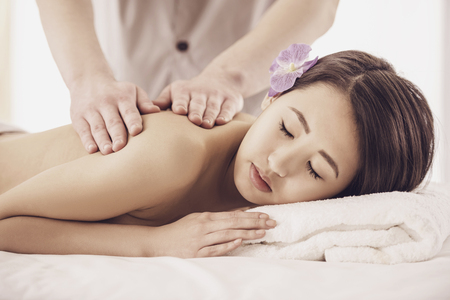 Side view. Beautiful asian woman having massage in beauty salon.の写真素材