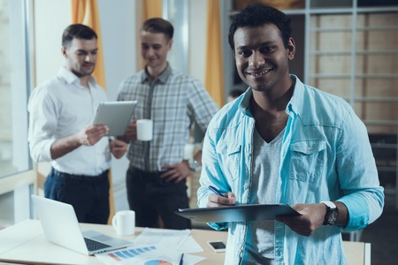 Multiethnic team of young successful creative people is working on common project. Startup. Conception of new business.の写真素材