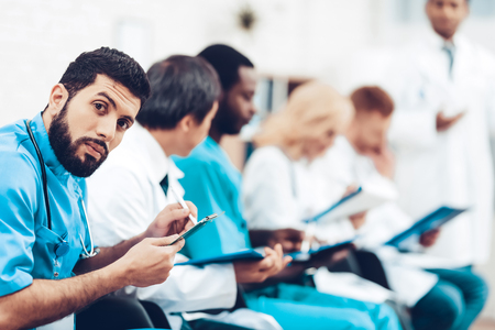 Indian Specialist Consultation. Medical Experience Sharing With Colleagues. Paper Desk Information. Latin Doctor Stare. Multinational Medician Meeting. Teamwork Connection. Clinician Team Group.の写真素材