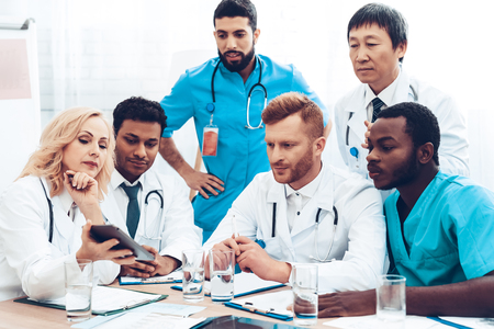 Doctors Meeting. Diagnostic Discussion. Multinational Medicals. Professional Consultation. Patient's Test Results. Young Specialists. Clinician Team Group. Physician Assistants. Sitting Interns.の写真素材