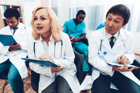 Multinational Doctor's Notes. Doctoral Conference Meeting. Writing On Papers. Lecture Discussing. Professional Medical Seminar. Teamwork Connection. Clinician Team Group. Working Together.の写真素材