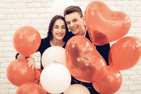 Happy Couple Posing With Baloons. Saint Valentine's Day. Love Each Other. Romantic Holiday. Sweetheart's Celebration Concept. Young And Handsome. Feelings Showing. Cheerful Lovers.の写真素材