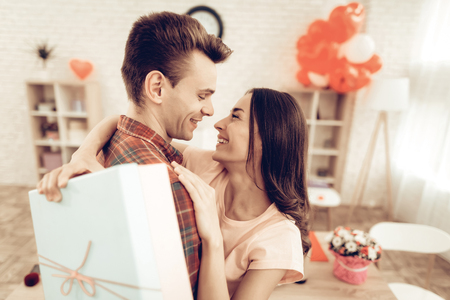 Guy Makes A Gift To Girlfriend On Valentine's Day. Love Each Other. Sweetheart's Romantic Moment Concept. Young And Handsome. Happy Relationship. Feelings Showing. Present Holding.の写真素材