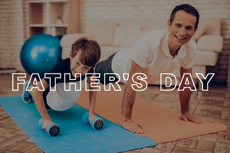 Father And Son Are Exercising With Fitness Ball. Healthy Lifestyle. Active Holiday. Exercises Clothes. Getting Better. Working Out At Home. Sports Equipment. Repeating Practice. Body Shaping.の写真素材