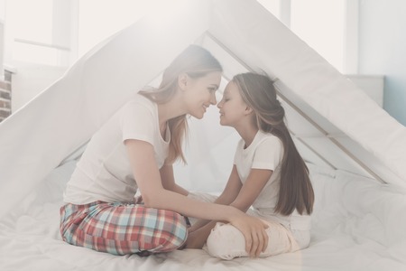 Young Happy Mother and Little Doughter Together. Beautiful Smiling Woman spending time with Cute...