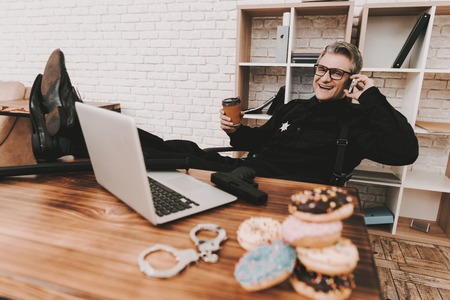 Smiling Policeman In Department Office. Relaxing Concept. Coffee Break. Cop's Donuts. Working...