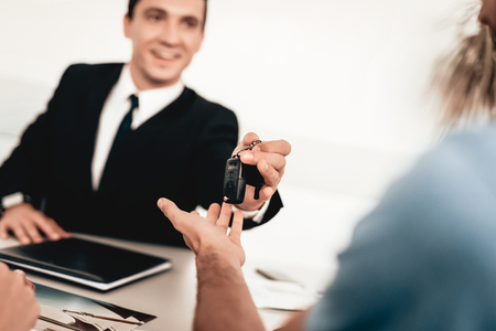 Showroom Dealer The Gives Car Keys To The Buyer. Dialogue With Dealer. Cheerful Customer. Automobile Salon. Make A Decision. End Of A Deal. Good Offer. Purchase Order. Happy Family.の写真素材