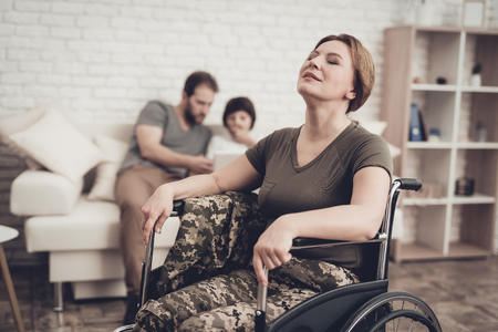 Disabled Soldier Woman In Wheelchair Concept. Meeting After War. Son And Husband Background. Camouflage Uniform. Family Background. Paralyzed Soldier. Home Leisure. Return From Army.の写真素材