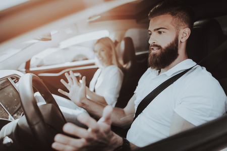 Man Behind The Wheel Of  Car. Girl At Front Seat. Innovation Technology. New Generation Electro Hybrid Vehicle. Luxury Design. Futuristic Power. Fasten Seatbells. Test Driving.の写真素材